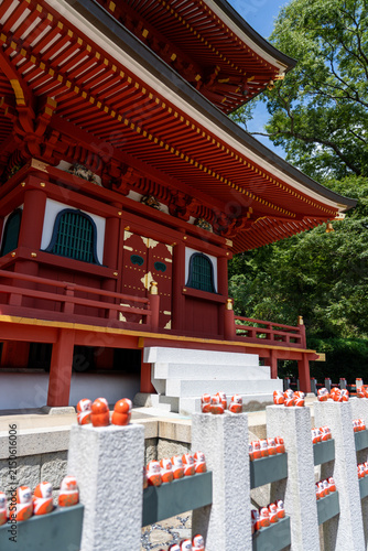 Vermilion Temple Hall with Daruma Dolls Lined on Fence