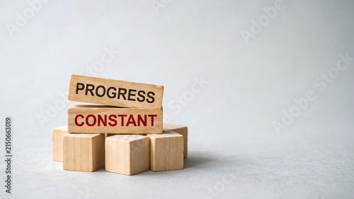 Progress concept with wooden blocks representing constant growth, development and achievement