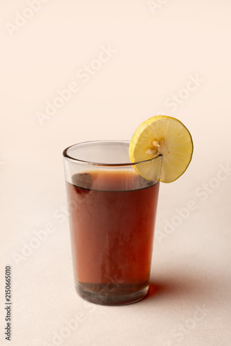 Glass of lemon tea with sliced lemon