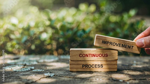 Continuous improvement and process development concept with wooden blocks in nature