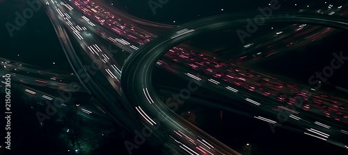 Expressway top view, Road traffic an important infrastructure, car traffic transportation above intersection road in city night, aerial view cityscape of advanced innovation, financial technology