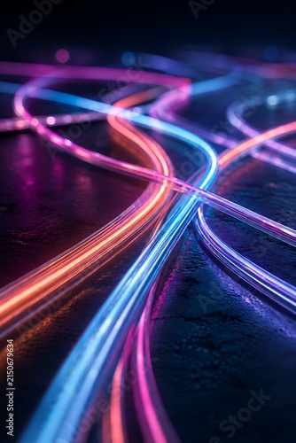 Abstract illuminated curved glowing neon light lines flowing in orange pink and blue colors over dark glossy surface floor