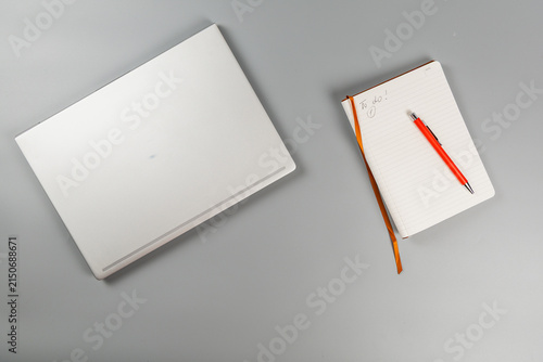 Foto Planning work tasks with a laptop and a notebook on a desk