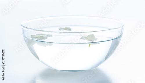 White Blossoms Floating in Clear Glass Bowl with Water for Wellness and Aromatherapy