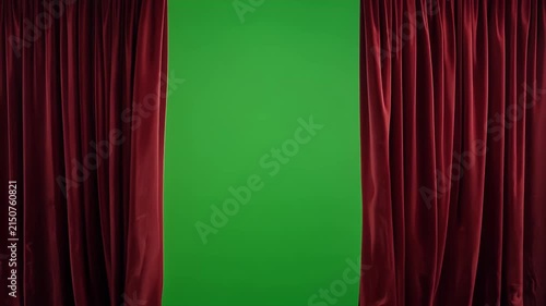 A parted red velvet curtain reveals a green background.