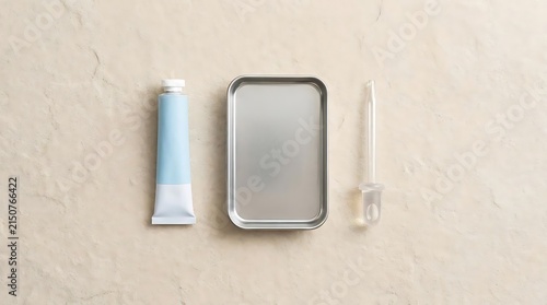 Cosmetic tube and metal container on beige stone.