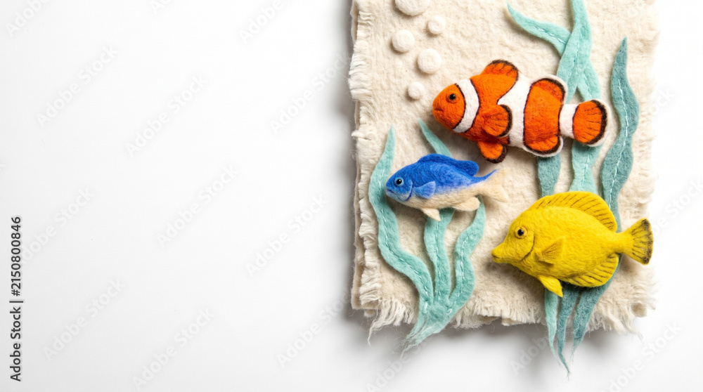 Fototapeta premium Colorful fish made of felt with seaweed on textured background 