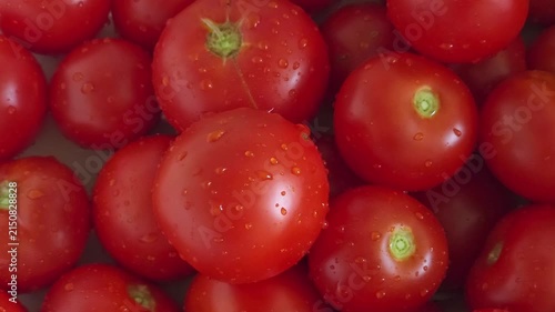 Heap of ripe red tomatoes close up, organic food background, fresh market harvest, healthy nutrition.