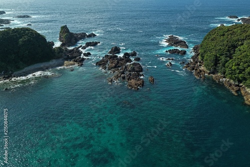 Aerial drone photo of rocky coastline and clear shallow sea in Kushimoto, Wakayama, Japan