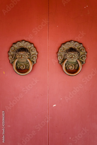 Fotografie Chinese-style antique vermilion red door with beast mouth door knocker