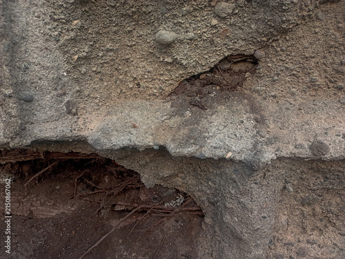 Close-up shot of a ruined damaged wall showing broken bricks and cracked concrete texture
