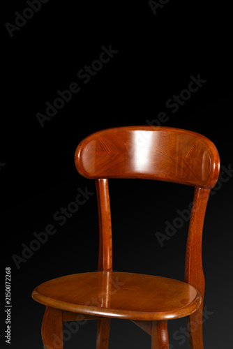 Canvas Print Still life of retro brown wooden chair on black background