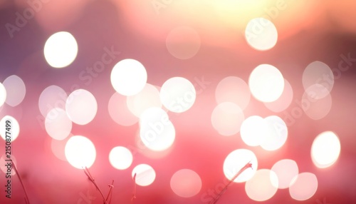 Soft White Bokeh Lights Over Faded Pink and Gold Blurred Background