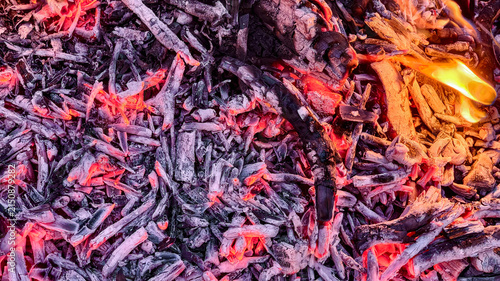 Obraz na plátně Campfire background with glowing embers and live fire flames.