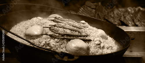 Quadro su tela Aromatic pilaf is fried in a cauldron