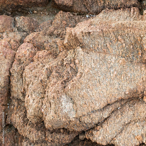 Natural red rock texture with coarse surface detail and weathered mineral patterns.