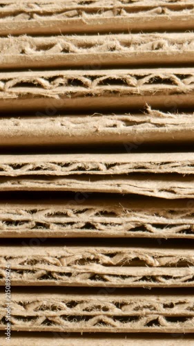MACRO: Stack of cardboard sheets shrinks