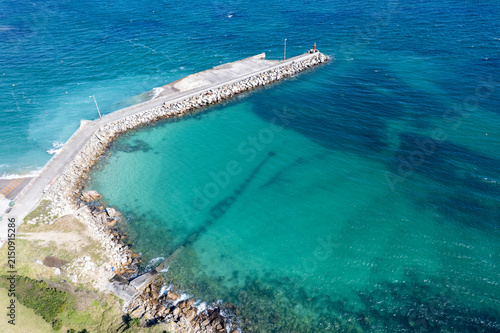 Aerial drone view of coastal breakwater in turquoise ocean water The Concept of coastal protection