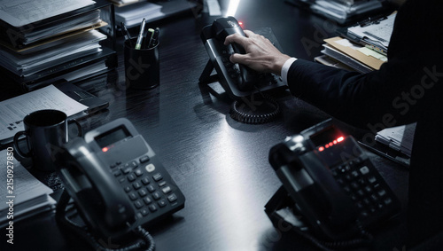 Hand Reaching for Telephone in Professional Office Environment