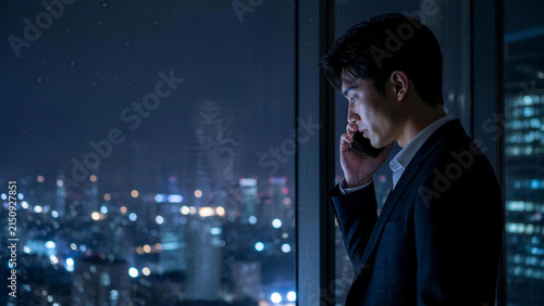 Business Professional on Phone with City View at Night