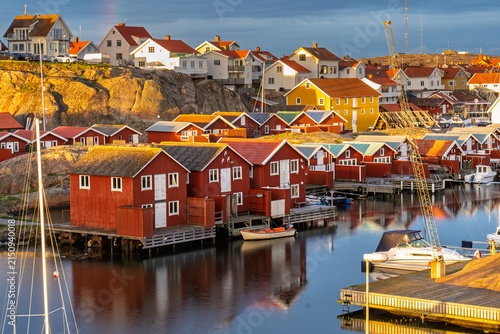 Smögen fishing village harbor with colorful wooden houses and boats, Sweden