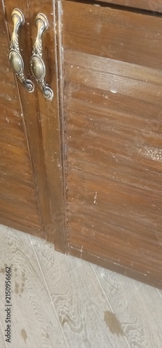 Bild auf Leinwand Close up of dusty and dirty wooden cabinet doors with vintage metal handles in a