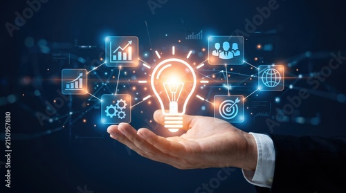 Glowing light bulb held in hand surrounded by innovation icons, representing creative business ideas, strategic planning, global growth and successful teamwork concepts
