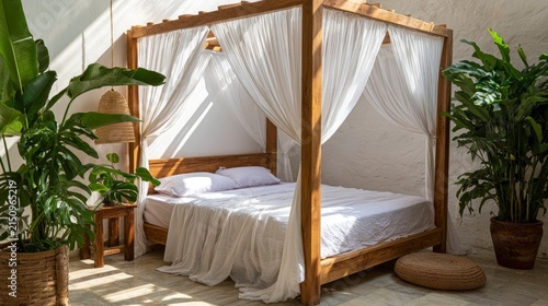 Elegant four-poster bed with white canopy in cozy bedroom with greenery decor