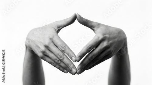 Black and white close up of two hands forming a diamond shape with fingers isolated against a plain white background studio