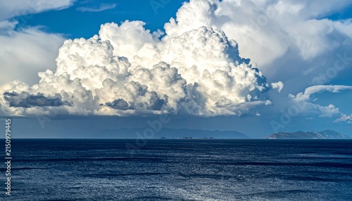 Majestic cumulus clouds over tranquil ocean horizon
