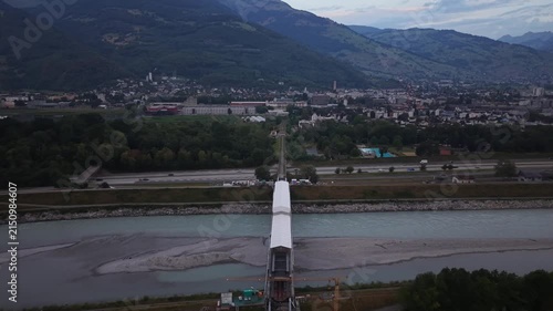 Drone flight along a railway bridge enclosed by a temporary protective roof during renovation, with additional railway construction visible farther toward the city.