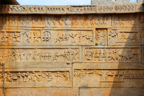 Ancient stone temple ruins and historic carved architecture in Hampi, India. Beautiful landscape with archaeological site, cultural heritage landmark and popular international tourist destination.