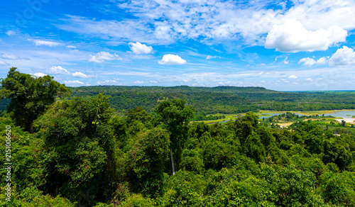 Overhead view. Beautiful landscape and mountains. Lake in vast forest with a large area.There is decrease in amount of water. It appeared that a mound of land had turned into grass field.