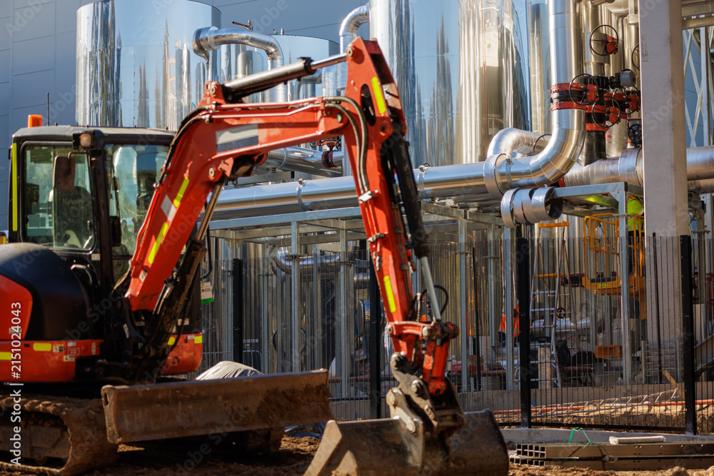 Fototapeta premium Data center construction site with excavator and cooling plant