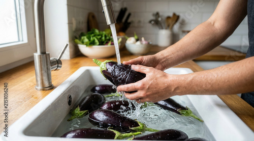 Fresh Eggplant Washed Under Running Water In A Kitchen Sink