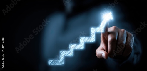Man Points to Glowing Upward Staircase Representing Business Growth