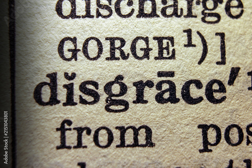 Konstfotografi Word disgrace printed on dictionary page, macro close up.