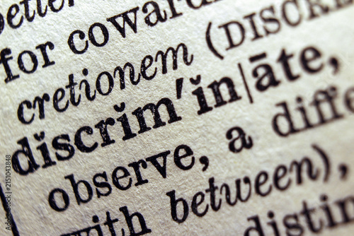 Foto Word discrimination printed on dictionary page, macro close up.