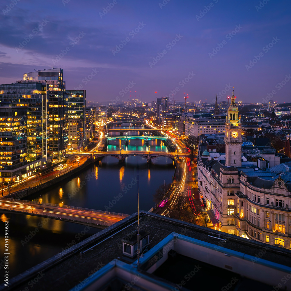 Fototapeta premium Dublin City Skyline at Dusk with River, Bridges and Illuminated Urban Buildings