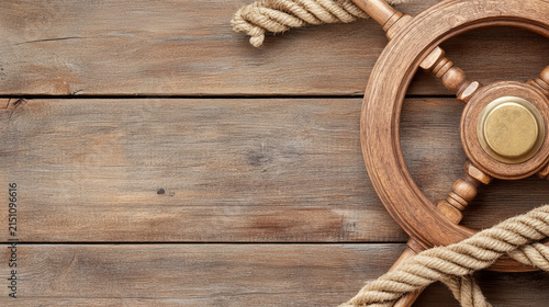 Close up of weathered wooden ship wheel with rope on rustic wooden background, evoking nostalgia