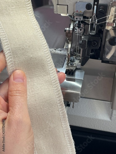 Process of Overlocking Fabric Edges Using an Industrial Serger Machine in a Tailoring Workshop