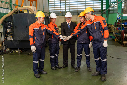 Obraz na plátne Engineer factory worker teamwork helmet safety uniform industry team joining han