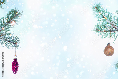 Winter Christmas Background with Pine Branches, Snowflakes and Festive Ornaments.