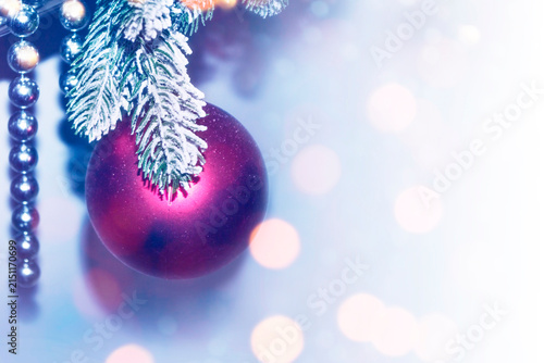 Home holiday decor. Christmas ball. Natural Christmas background. Fir branches. New Year's decoration on a spruce branch in the snow.