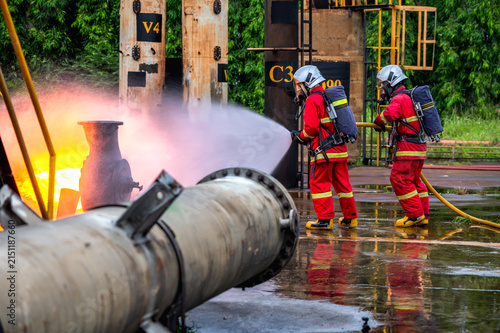 Canvas Print Team of male firefighters in full protective gear and SCBA equipment work togeth
