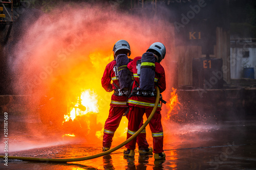 Fotografía Team of male firefighters in full protective gear and SCBA equipment work togeth
