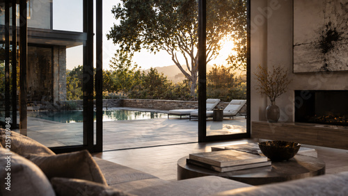 Luxurious living room with large glass doors opening to a scenic backyard with a swimming pool and sun loungers at sunset, warm golden light streaming in