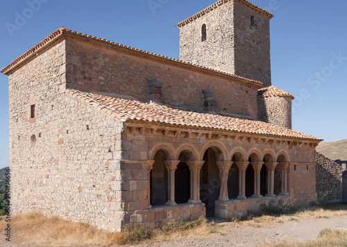 Fotografie Ancient Romanesque sanctuary rising toward a sharp, radiant afternoon sky