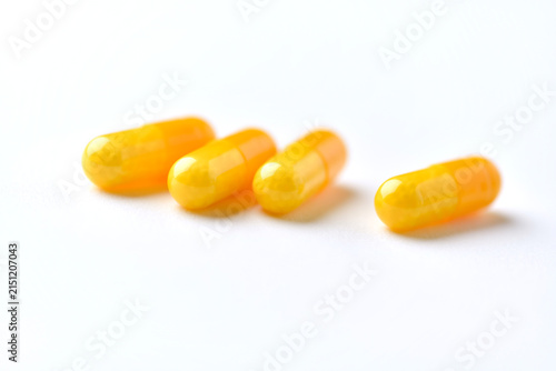 Vitamin C capsules. Antioxidants. Concept for a healthy dietary supplementation. Bright paper background. Soft focus. Close up. Copy space.