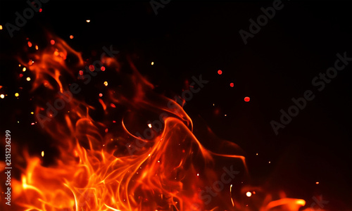 Dramatic fire flames with glowing embers and sparks on black background